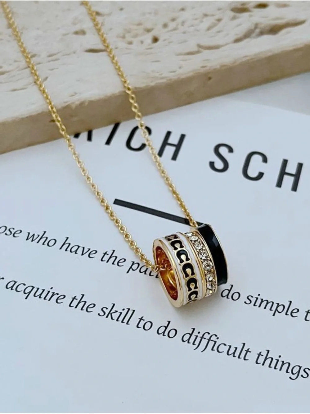Coach Gold-Tone Pendant Necklace with Black Enamel and Crystal Band